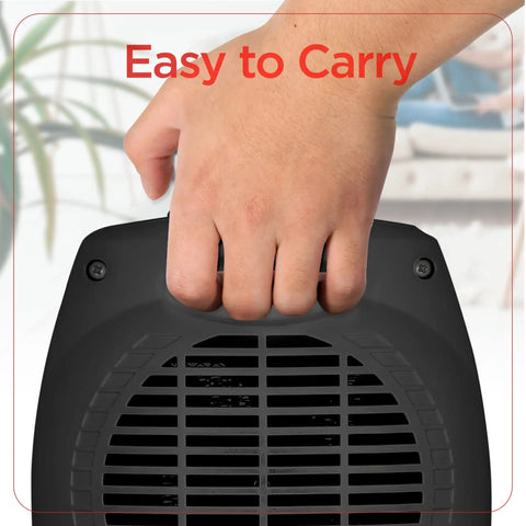 Hand holding a black compact Small Space Heater 1500W Ceramic Indoor Heater with 3 settings, showing it's easy to carry.
