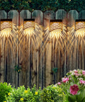 Two Pack Solar Fence Lights Outdoor Waterproof Patio Decor with Glowing Elk Pattern illuminating a wooden fence at night