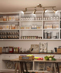 Gold LED Track Lighting Kit With Adjustable Ceiling Spotlights illuminating a kitchen pantry with rotatable downward heads.
