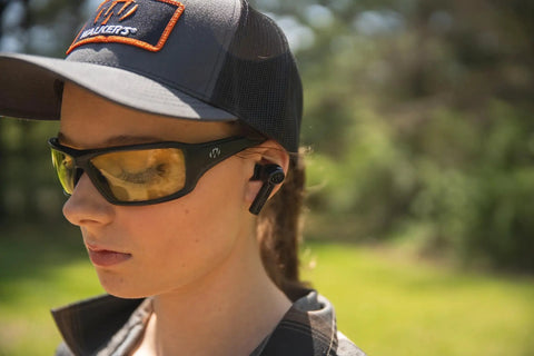 Person wearing Disrupter Bluetooth Earbuds For Hunting And Range Shooting Active Lifestyle Beast Mode Hearing Protection outdoors