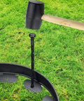 Spiral Landscape Anchoring Spikes 8 Inch Set For Lawn Edging Tough As Nails Durable Plastic Stakes in use with rubber mallet on grass