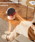 Electric Space Heater And 2 In 1 Fan Combo 1200W Portable Desk Heater warming room with person holding a cup on couch