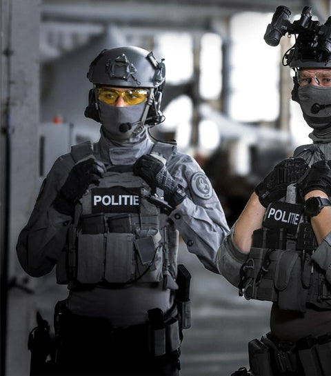 Policemen wearing tactical gear in a facility with M Pact Covert Tactical Gloves With Secure Fit For Men, Tough As Nails Touchscreen Capable Work Gloves With Impact Protection And Vibration Absorption, 0.8mm Synthetic Leather Black X Large.