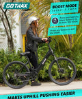 Rider with helmet on black 26 Inch Electric Bike With 350W Brushless Motor Up To 20 MPH, 30 Mile Pedal Assist Range, Front Shock, 7-Speed