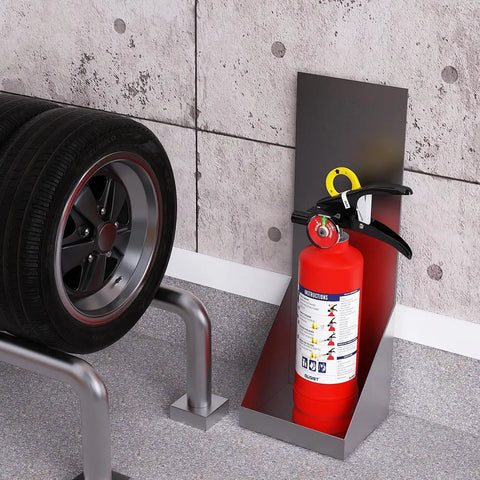 No Fuss ABC Home Fire Extinguisher 2.5 Lb Two Pack near vehicle tires in garage, portable safety gear for fire emergencies.