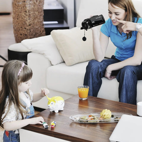 Person using Dope 4K Video Camera WiFi Ultra HD Camcorder With 18x Digital Zoom near child playing at table indoors