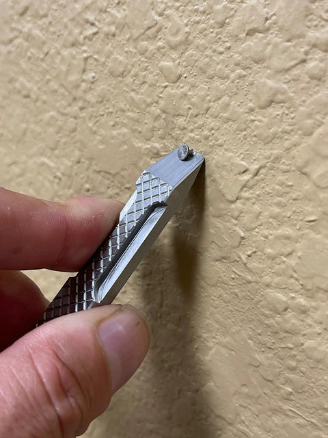 Everyday Carry Mini Pry Bar Keychain With Screwdriver And Box Opener Heavy Duty Stainless Steel EDC Tool in use on a wall