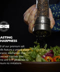 Pepper Grinder With Adjustable Six Level Grind, Stainless Steel Mill in use, grinding pepper onto a fresh green salad bowl.