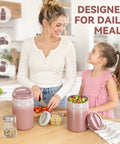 Big 27oz Wide Mouth Food Jar Made From Stainless Steel Keeps Your Grub Hot For Ten Hours Straight Up Leak Proof Performance Locks In Chill Till Midnight Perfect For Grab And Go Work Or School Vibes Pink with a woman and girl preparing meals.
