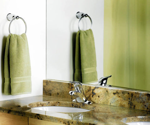 Chateau Chrome One-Handle Low Arc Centerset Bathroom Sink Faucet With Drain Assembly on marble counter next to green towel