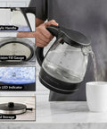 Person using 1.5L Borosilicate Glass Electric Kettle With Auto Shut Off, Boil Dry Protection, BPA Free, Black Finish, Blue LED Halo.