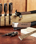 Pro Grade 9.5 Inch Trim Bar And Pry Bar Set With High Carbon Steel Built In Ruler Beveled Edges Nail Puller And Siding Nail Puller 2 Pack Donates 3 Percent To Veterans on a wooden table with tools