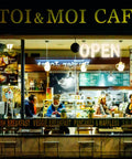 Nighttime view of café with 30x10 Inch LED Open Sign For Business With Boss Level Brightness, warm ambiance inside.