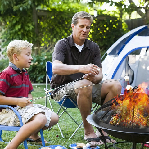 Father and son using 24 Inch Fire Pit Spark Screen with Foldable Hook and Marshmallow Sticks, Heavy Duty Steel Mesh Cover