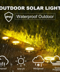 Solar Ground Yard Lights 16 Pack Easy Install Waterproof Disk LED In Ground Lights illuminating a wet garden path
