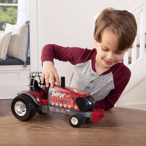 Child playing with Case IH Barn Buster One Sixteenth Scale Pulling Tractor With Thunder Engine Sounds Free Rolling Wheels Chrome Rims