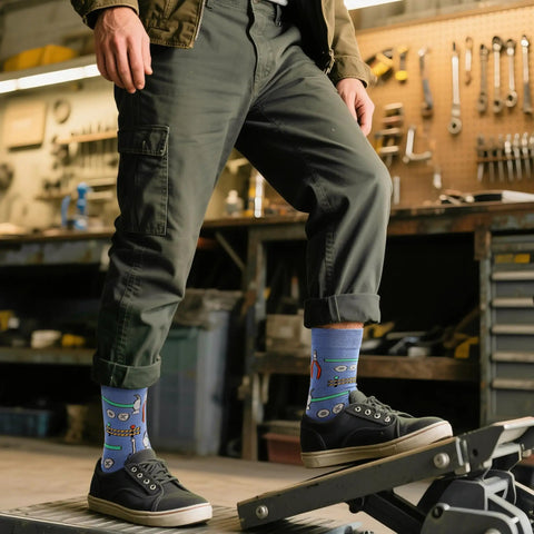 Man in workshop wearing Three Pack Mechanical Engineering Socks Gift Set For Gearhead Men And Techy Dads with tool prints size 7-13.