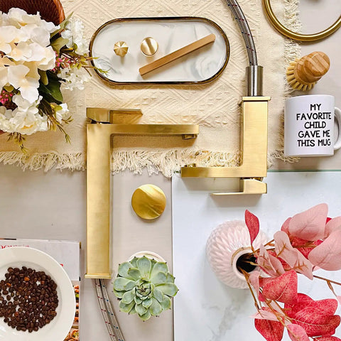 Gold Vessel Sink Faucet in Brushed Gold Finish, Tall Single Hole Bathroom Faucet on table with decor items and flowers
