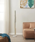Callie LED Floor Lamp 55 Inch Tall Industrial Style With Metal Grid Shade next to a sofa in a modern living room