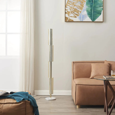 Callie LED Floor Lamp 55 Inch Tall Industrial Style With Metal Grid Shade next to a sofa in a modern living room