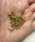 Brass Miniature Screws Set 50 Pieces M2 6mm For Model Building And Dollhouse Hobbyists DIY in a hand close-up view.