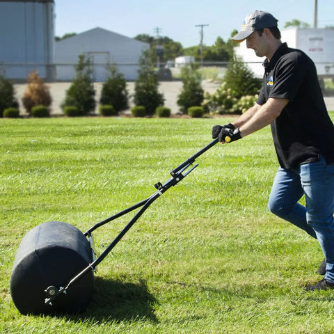 Man using Spyker 300lb Push Tow Commercial Lawn Roller With No Tools Handle, Beefy Heavy Duty Drum, Turf Safe Rounded End Caps