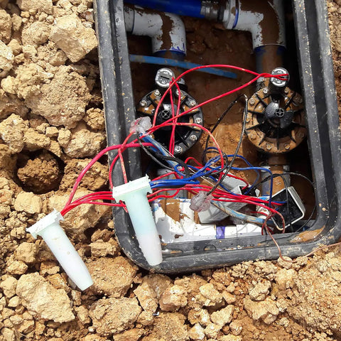 Direct Burial Wire Connector DryConn DIY Friendly Blue Waterproof Sealant used in outdoor electrical box installation.