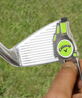 Person using Super Handy Four In One Golf Divot Repair Tool Built With Tough Zinc Alloy For Avid Golfers Looking For A Reliable Multi Function On Course Accessory That Makes A Great Gift on iron club.