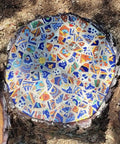 Round mosaic made from 10 Pound Bundle Of Broken Mexican Talavera Tiles For Mosaic Projects And DIY Decor, vibrant colors and patterns.