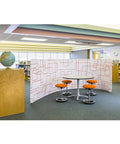 Library scene with four Twixt Active Movement Seating Chair With Ergonomic Support Desk Height Adjustable Comfy Orange Mesh Office Chairs around table