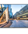 86 Inch 4K UHD Screen With Straight Fire HDR Clarity Built For Bold Digital Signage Displays And Modern Workspaces featuring a cityscape.