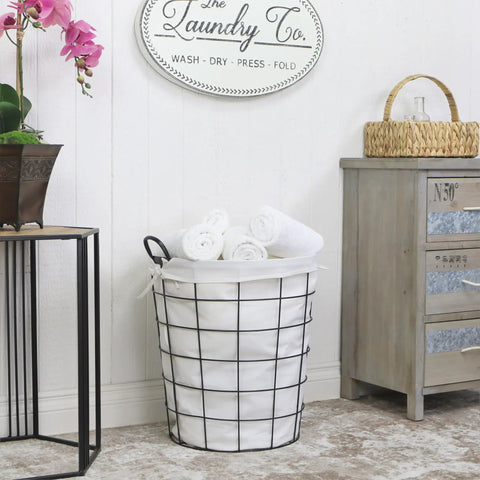 16 Inch Metal Wire Basket With Linen Fabric Liner And Side Handles For Laundry And Home Storage in a laundry room