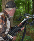 Hunter with crossbow using 36 Pack White And Neon Orange Arrow Vanes For Broadhead Crossbow And 3D Archery Universal Vane Set in forest