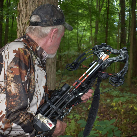 Hunter with crossbow using 36 Pack White And Neon Orange Arrow Vanes For Broadhead Crossbow And 3D Archery Universal Vane Set in forest