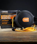 Compact Retractable Air Hose Reel with brass fittings, 1/4 inch by 65 feet, mounted on wooden surface.