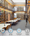 Modern library interior with long tables and bookshelves, featuring Amber Glass Bankers Desk Lamps for study areas.