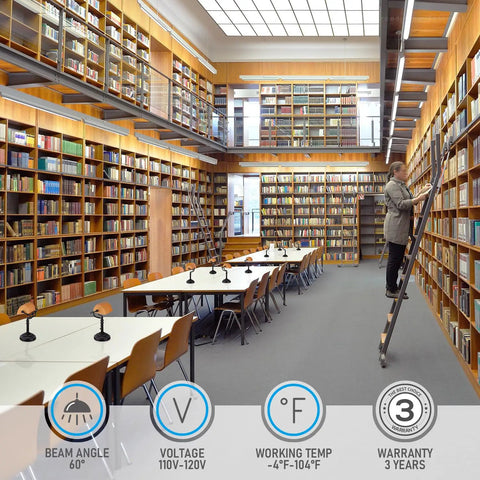 Modern library interior with long tables and bookshelves, featuring Amber Glass Bankers Desk Lamps for study areas.