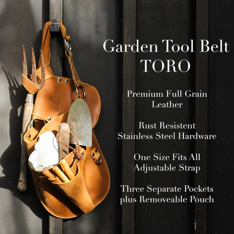 Durable Leather Garden Tool Belt For Women hanging on wall with pruners, trowel, and fork, showcasing adjustable brown leather design.