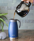 Pouring coffee into Stainless Steel Thermal Carafe Dispenser Vacuum Insulated Dual Wall Bottle For Hot Coffee Tea Or Cold Water 1.5 Liter 50oz Keeps Drinks Hot 12 Hours Cold 24 Sweat Free Admiral Blue on kitchen counter