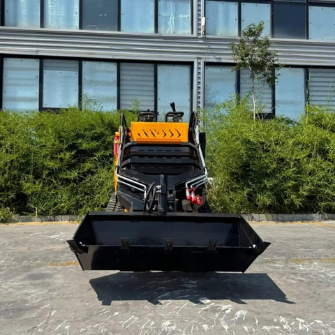 Front view of Beast Mode Skid Steer Loader with reinforced frame, showcased against backdrop of green plants and large windows.