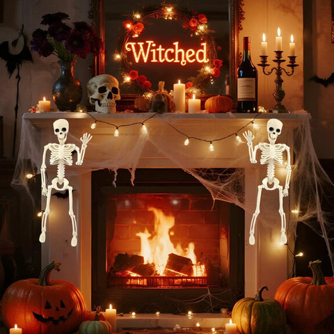 Two 15.7 Inch Hanging Skeleton Decorations With Full Body Posed Joints by a fireplace with pumpkins and candles, spooky Halloween decor