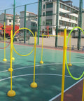 Drone Racing Obstacle Course Kit For Indoor And Outdoor Practice With Multiple Difficulty Levels Easy Setup Portable Training Course For Beginners And Pro Flyers Build Your Own Custom Racing Experience shown outdoors with yellow hoops on a court.