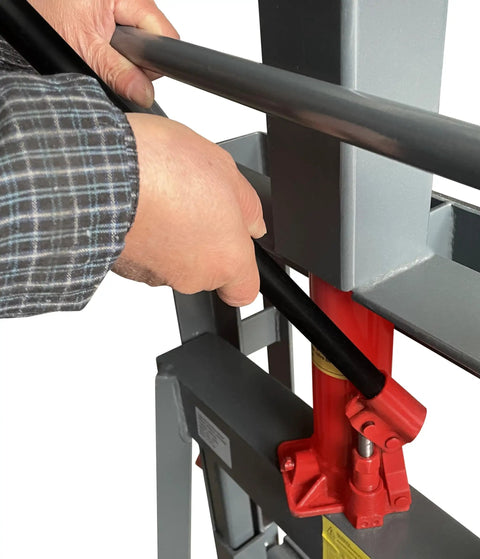 Hands operating lever of Beefed Up Heavy Duty 4,000 Lb Hydraulic Machinery Mover With Adjustable Forks From 4.5 To 19 Inches