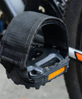 Two Pairs Kids Bicycle Foot Strap Pedal Straps For Fixed Gear Bikes Adjustable Nylon Foot Straps Durable Non Slip Pedal Straps Fits Most Shoes Great For Safe Secure Rides shown attached to a bike pedal.