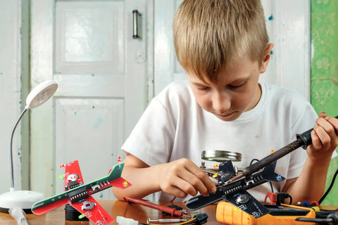 Child using Dope Soldering Practice Kit For Beginners Build Two Mini Display Aircraft With 3 Color LEDs A Hands On STEM