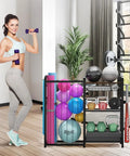 Garage Sports Equipment Organizer With Ball Storage Large Capacity For Gear And Toys Includes Hooks And Baskets For Basketballs Soccer Balls Footballs Golf Balls Bats And More next to woman holding weights.