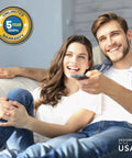 Happy couple using remote with Voltage Guard Surge Protector For Smart TVs And Gaming Consoles, Shields Your Home Theater Setup