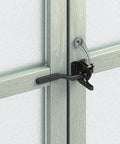 WUUWCHODC 2 Sets Spring Gate Latch Replacement Kit for Wood Fence on a wooden gate, featuring a black latch and spring mechanism.