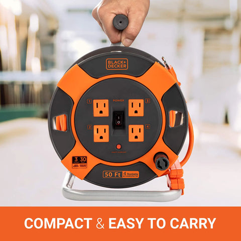Heavy Duty 50 Ft Retractable Extension Cord Reel With 4 Outlets, Easy Rewind Handle, shown being held, indoor setting