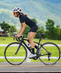 Cyclist riding on road bike, showcasing performance with Two Pack 700C Self Sealing Bike Tubes 35C To 43C Puncture Resistant AV48mm Valve